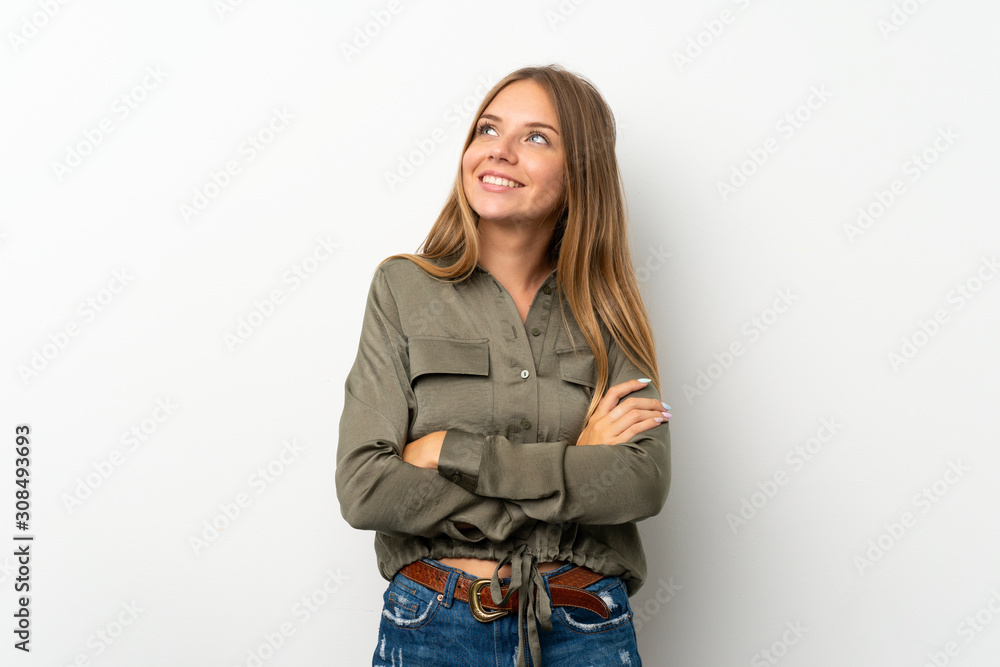 Lithuanian blonde girl over isolated white background looking up while smiling Lithuanian blonde girl over isolated white background looking up while smiling