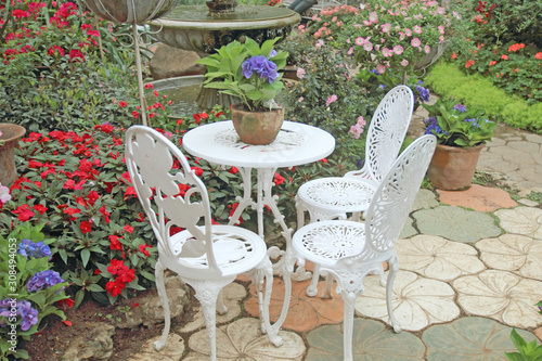 White chair set in a flower garden