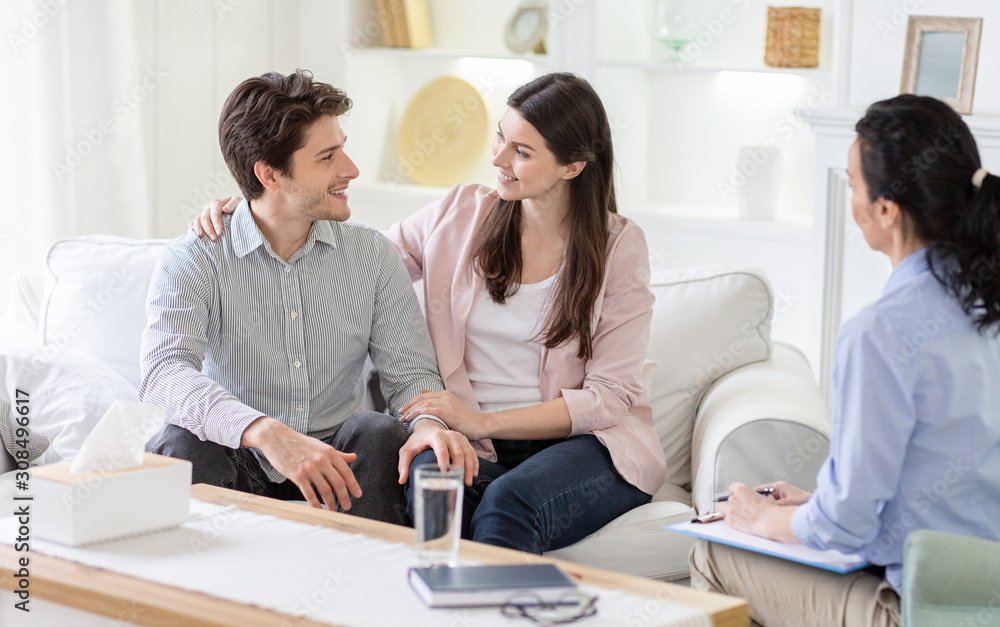 Happy couple cuddling and telling good words at marital session Happy couple cuddling and telling good words at marital session