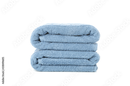 Folded blue towels isolated on white background, close up