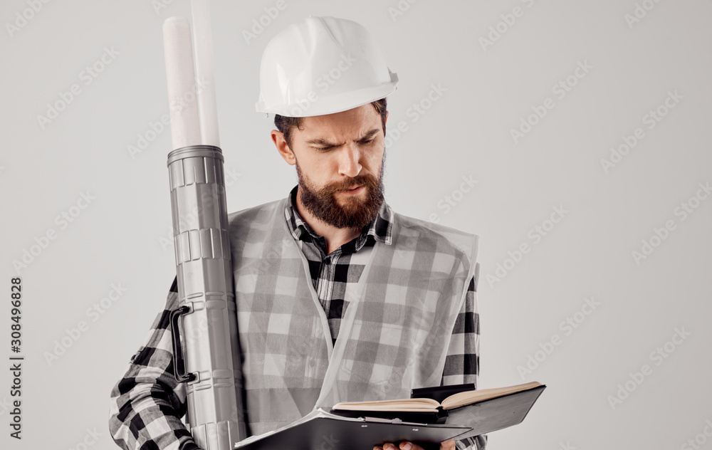 engineer in hard hat with blueprints