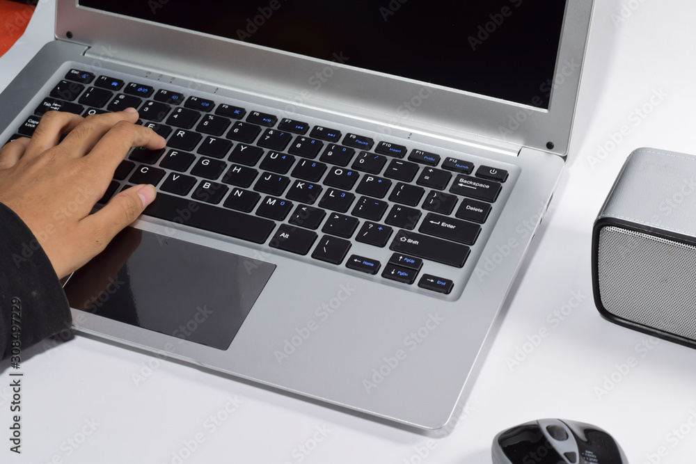 Female hands typing on laptop keyboard at the office. Female hands typing on laptop keyboard at the office.