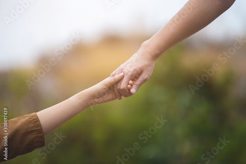 close up hands up man and woman holding hand together, love and help concept.