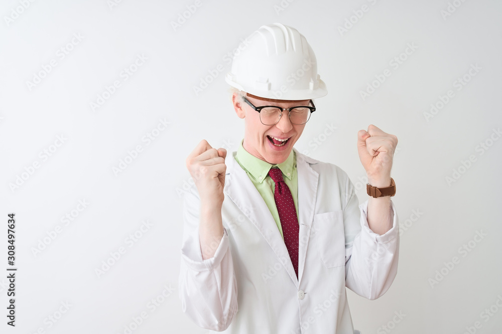 Albino scientist man wearing glasses and helmet standing over isolated white background celebrating mad and crazy for success with arms raised and closed eyes screaming excited. Winner concept Albino scientist man wearing glasses and helmet standing over isolated white background celebrating mad and crazy for success with arms raised and closed eyes screaming excited. Winner concept