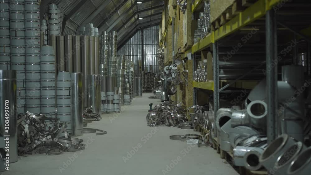 Metal production warehouse. Steel metal pipes and metal items stored in freight terminal. Steel industry, metal production, manufacturing. Camera moving from right to left. Metal production warehouse. Steel metal pipes and metal items stored in freight terminal. Steel industry, metal production, manufacturing. Camera moving from right to left.