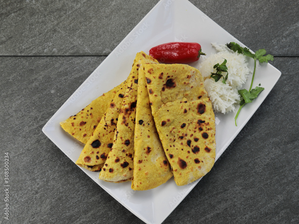 Home made Gluten free Chickpea flour Roti or Besan Roti or Chapati or bread on a plate . Home made Gluten free Chickpea flour Roti or Besan Roti or Chapati or bread on a plate .