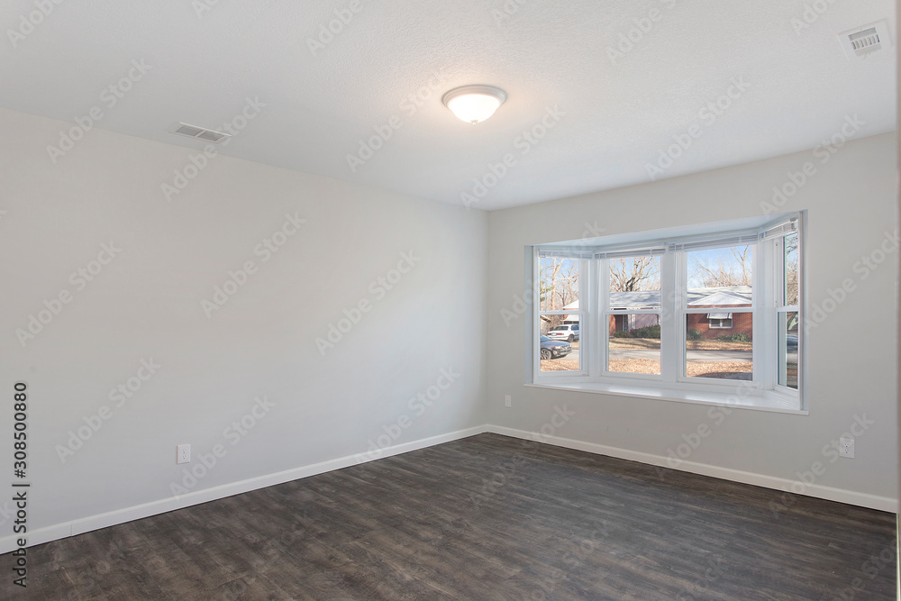 Model Empty Bedroom with White Walls and Harwood Floors Model Empty Bedroom with White Walls and Harwood Floors