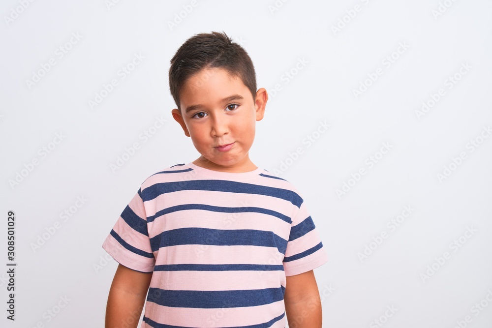 Beautiful kid boy wearing casual striped t-shirt standing over isolated white background depressed and worry for distress, crying angry and afraid. Sad expression. Beautiful kid boy wearing casual striped t-shirt standing over isolated white background depressed and worry for distress, crying angry and afraid. Sad expression.