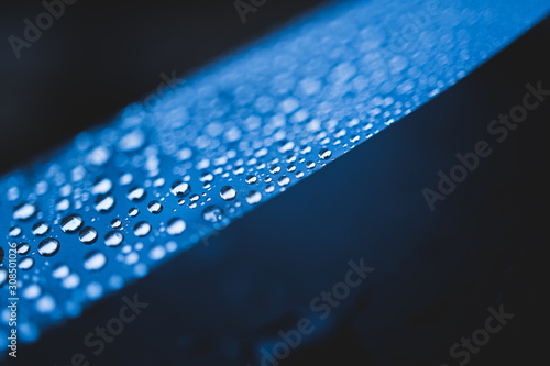 Macro shot of water drops on a thin film. Hydrophobic effect. Water-repellent or Water-resistant Concept. High Resolution Photography. photo