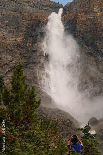 A visitor capturing the size and power of Takakkaw Falls in Yoho National Park, the second tallest waterfall in Canada, 