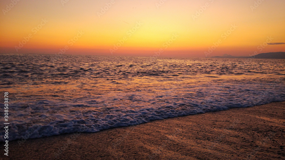 combination of Sunset and Beach. colorful orange sunset at the beach.
