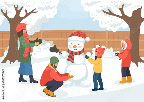 Family making snowman. Man, woman and children building snowman on the winter backyard.