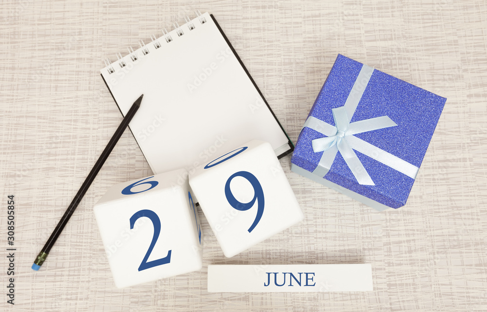 Calendar with trendy blue text and numbers for June 29 and a gift in a box.