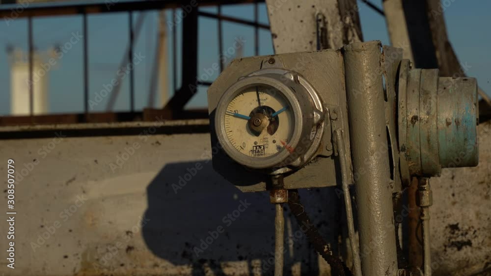 Oil production, oil pumping at dawn. Clouse up. Pressure gauge Oil production, oil pumping at dawn. Clouse up. Pressure gauge