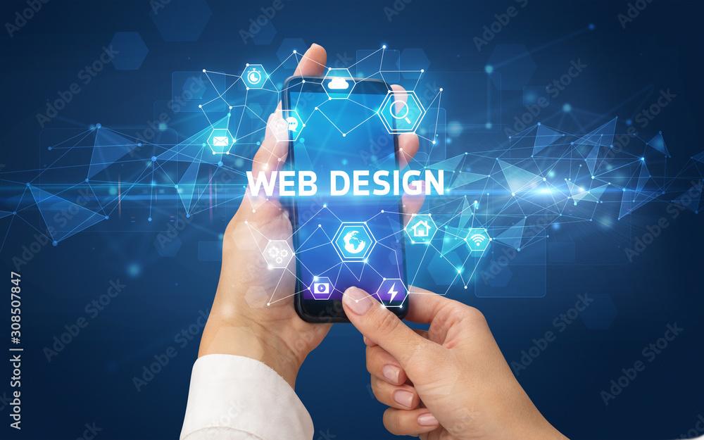 Female hand holding smartphone with WEB DESIGN inscription, modern technology concept Female hand holding smartphone with WEB DESIGN inscription, modern technology concept