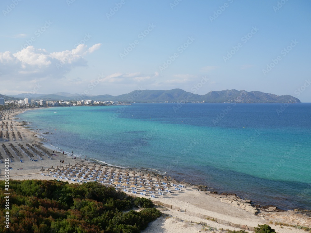 Obraz premium Aerial view of the sand, blue sea and sky of Cala Millor beach, Majorca