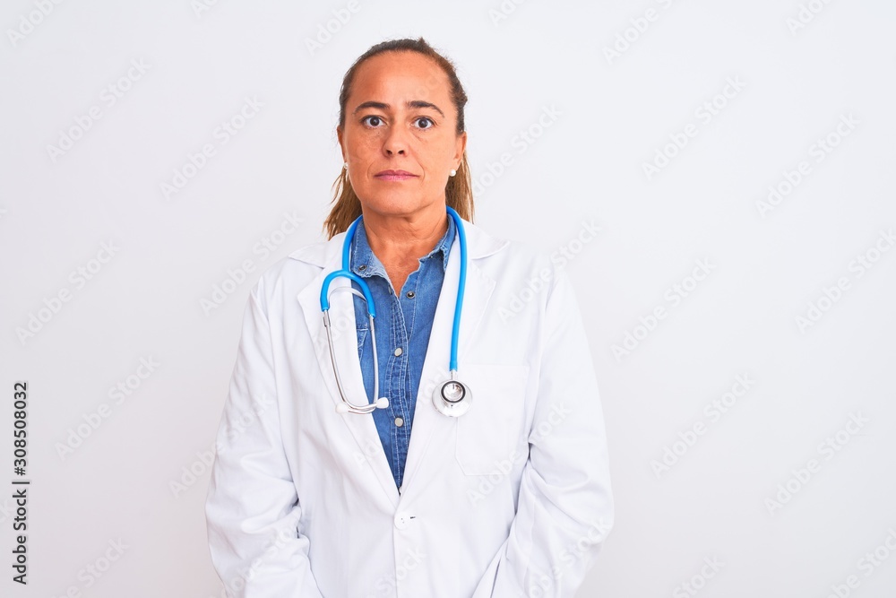 Middle age mature doctor woman wearing stethoscope over isolated background Relaxed with serious expression on face. Simple and natural looking at the camera.