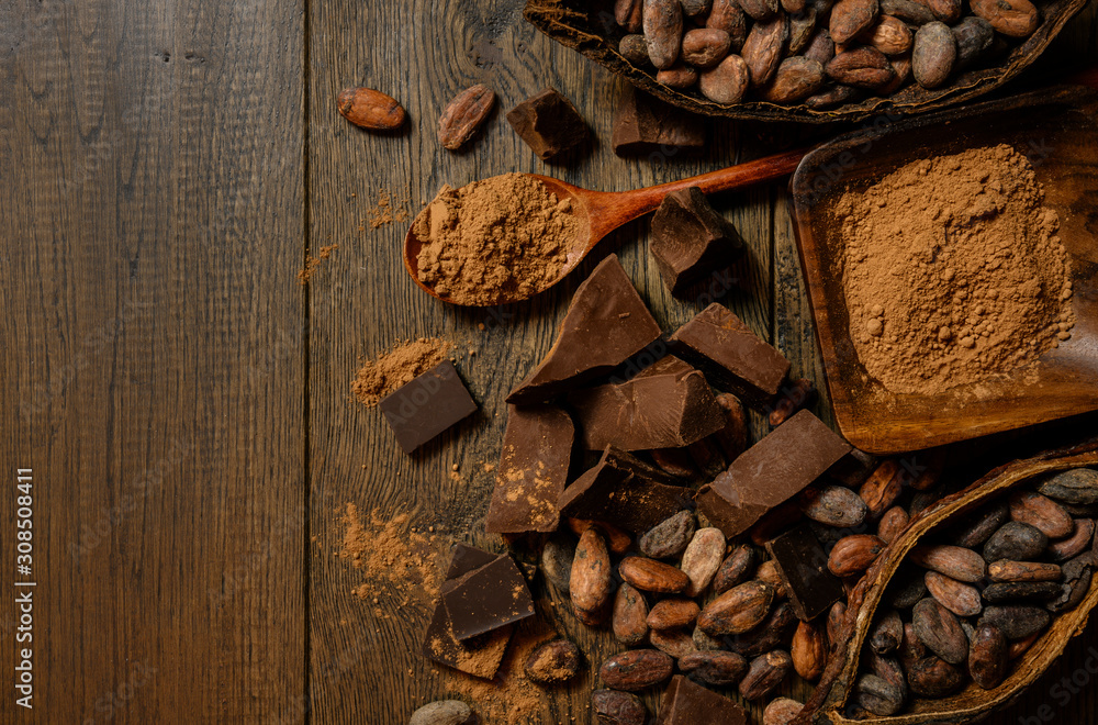 open cocoa fruit lies on a wooden table with cocoa beans open cocoa fruit lies on a wooden table with cocoa beans