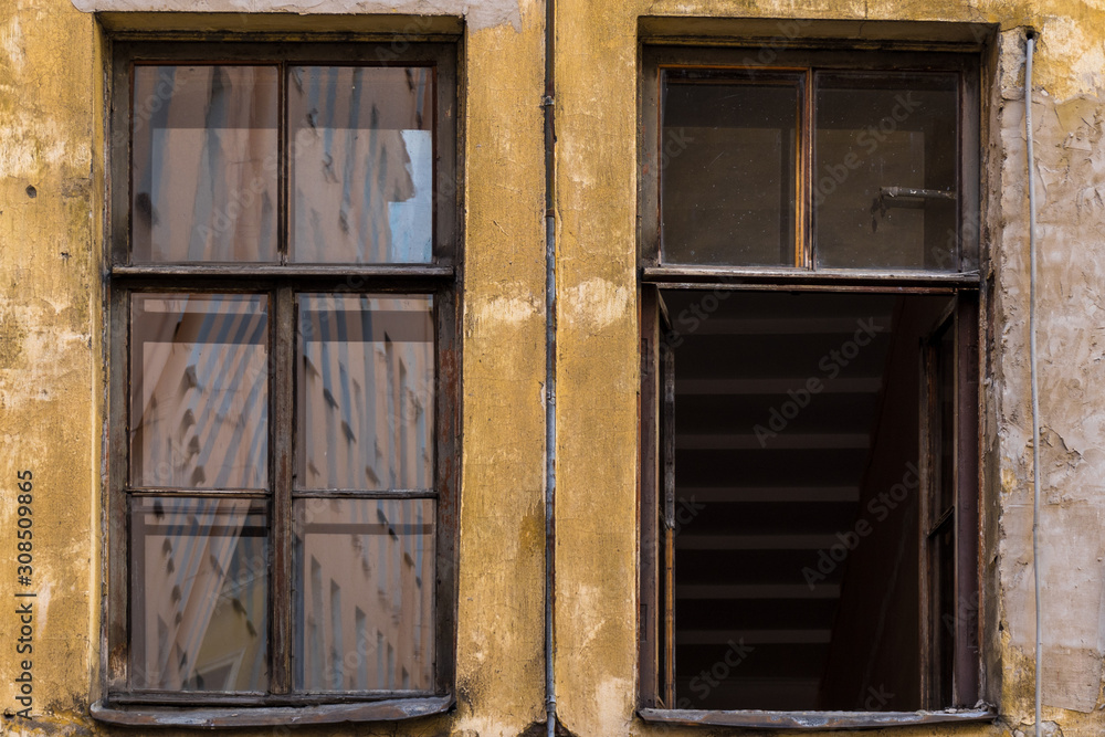 Two Windows on the yellow facade of the old house Two Windows on the yellow facade of the old house