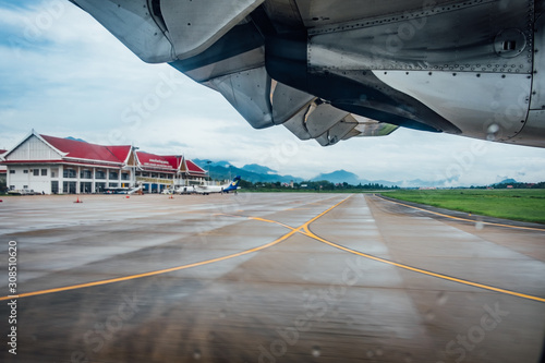 under the plane wing before take off on  runway at luangprabang international airport