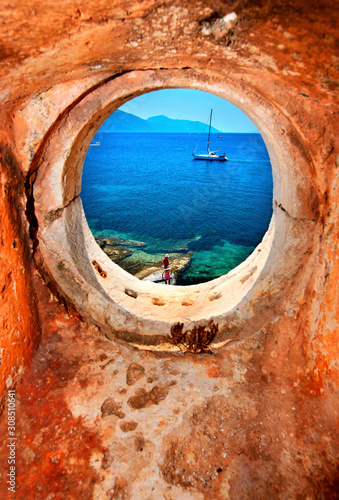 View to the Ionian sea through the window of an old, abandoned lighthouse close to Fiskardo town, Kefalonia island, Greece