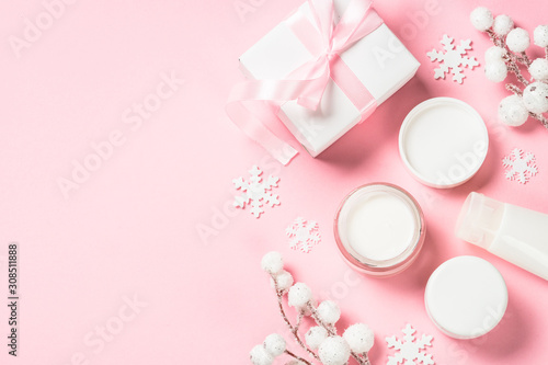 Winter cream for skin on pink top view. © nadianb