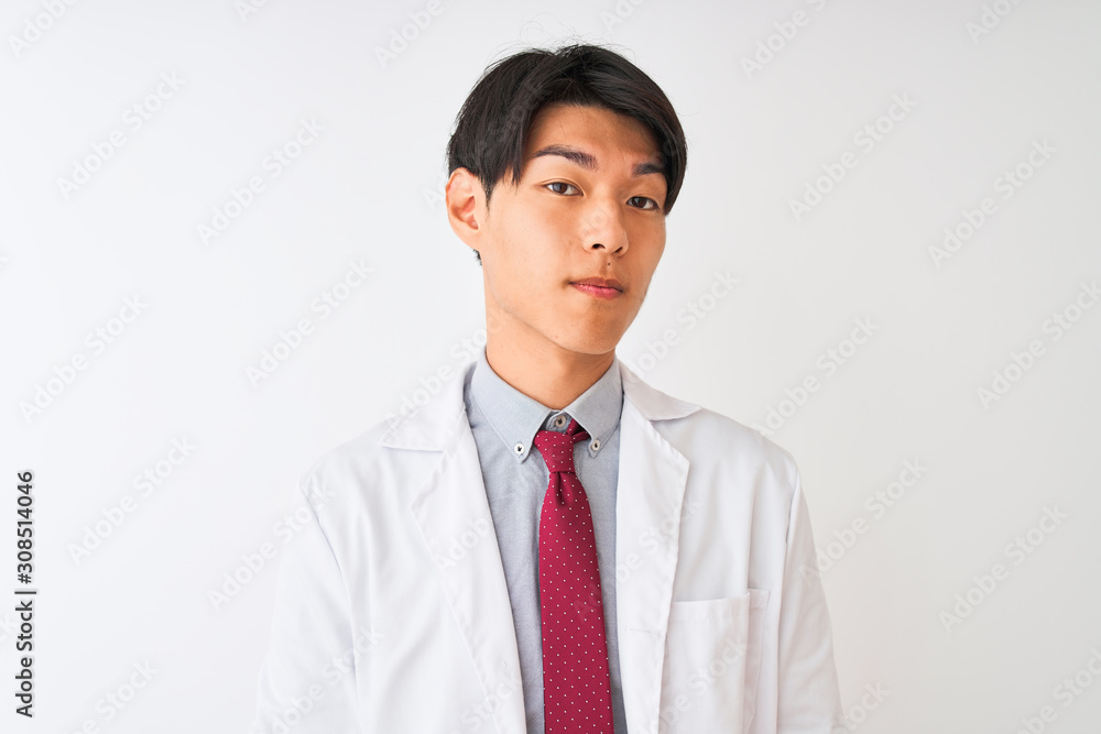 Chinese scientist man wearing tie and coat standing over isolated white background with serious expression on face. Simple and natural looking at the camera. Chinese scientist man wearing tie and coat standing over isolated white background with serious expression on face. Simple and natural looking at the camera.