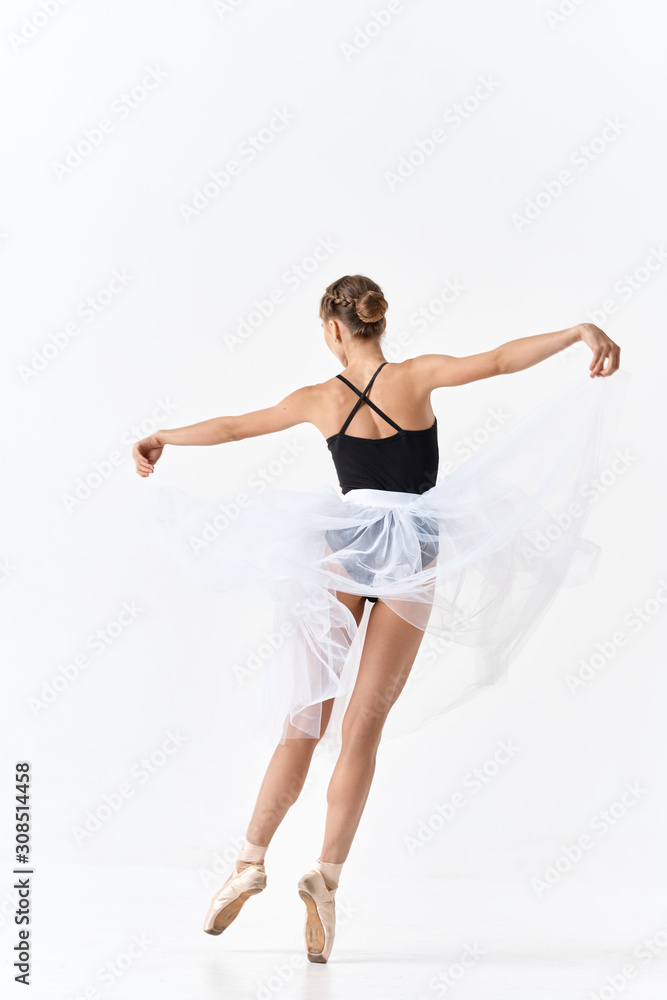 young ballet dancer posing on white background