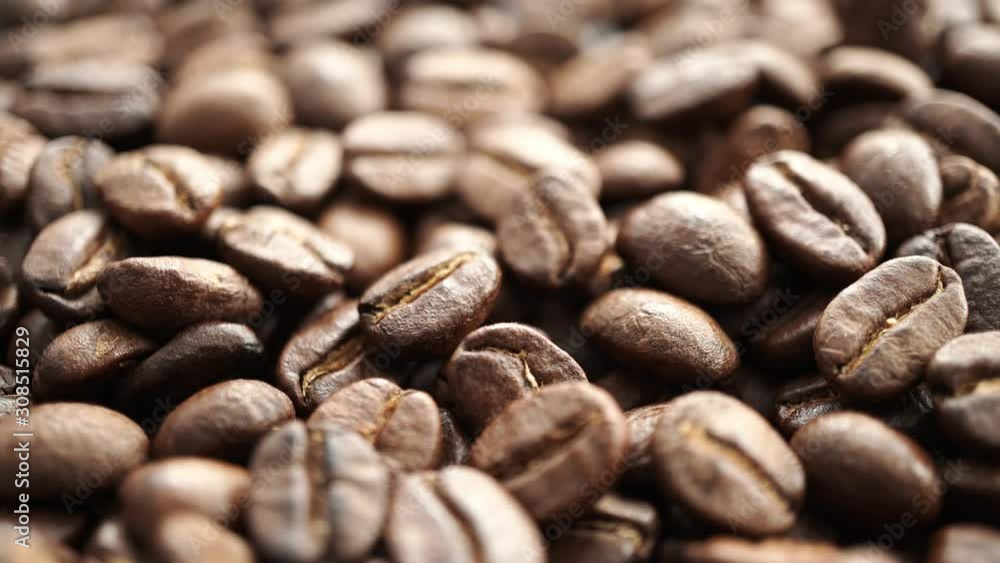 roasted coffee bean fast spinning clockwise, selective focus roasted coffee bean fast spinning clockwise, selective focus