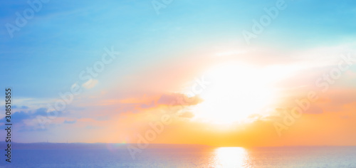 bright sunrise at sea,blurred background © Natalia