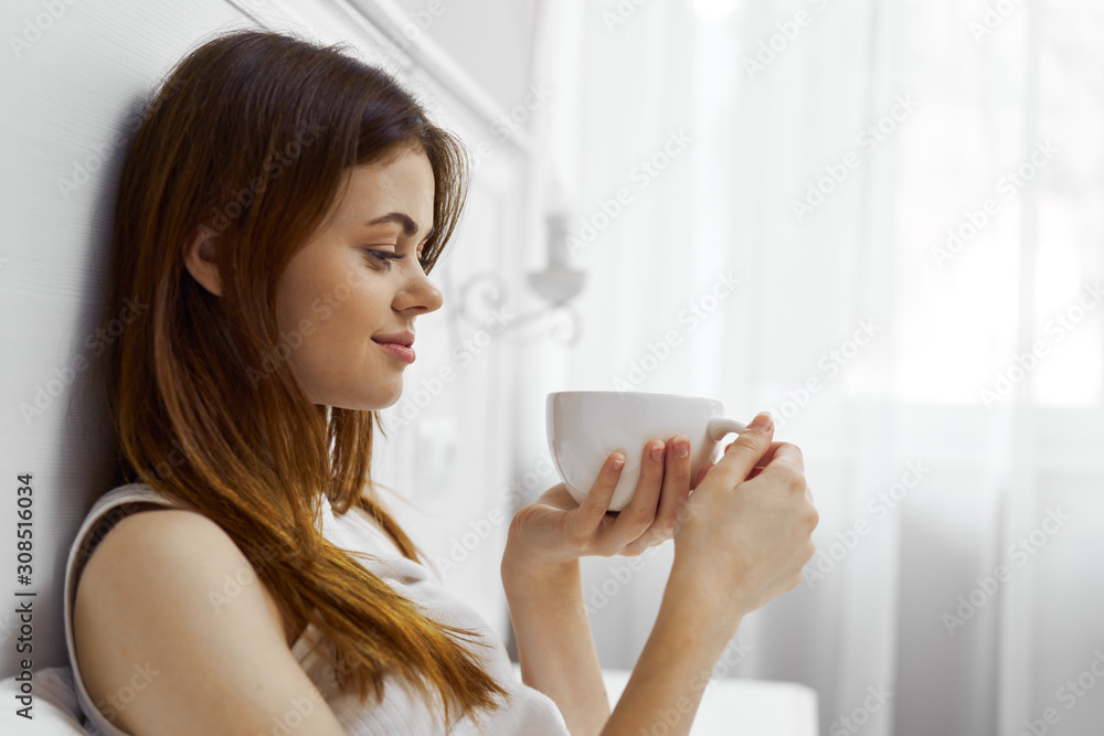 portrait of young woman drinking coffee in kitchen portrait of young woman drinking coffee in kitchen