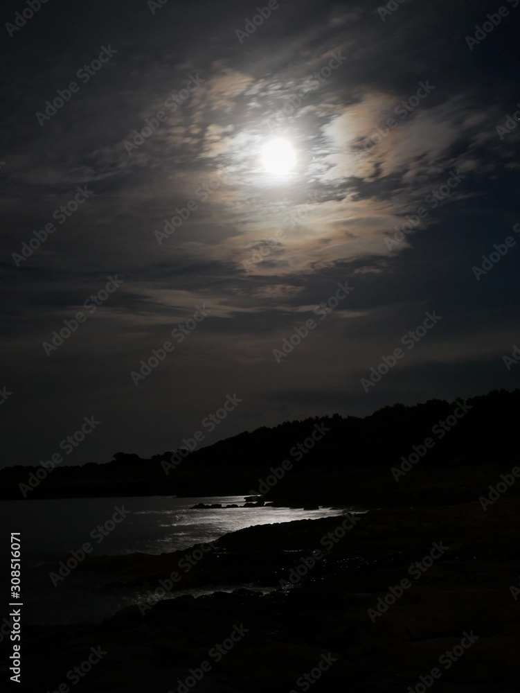 Night view of Cala Millor coastline and full glowing moon