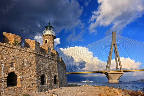 The castle of Antirrio with its lighthouse. In the background the multi-span cable-stayed Rio - Antirrio bridge. Municipality of Nafpaktia, Aitoloakarnania, Central Greece. photo