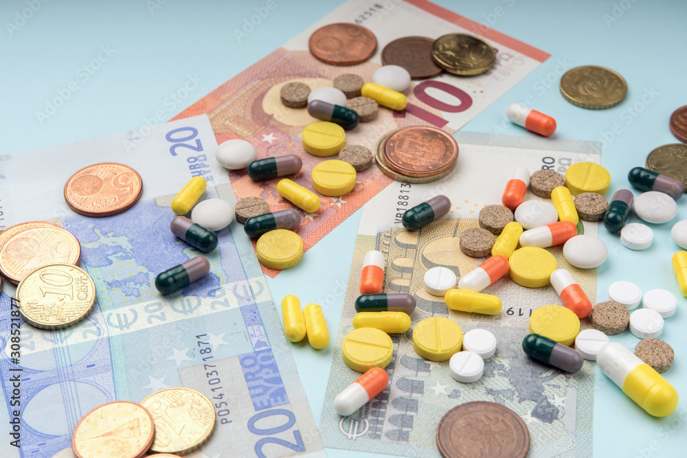 Colorful pills and capsules on dollar banknotes. concept of high cost treatment, preservation of health and medical insurance. Drugs and money Colorful pills and capsules on dollar banknotes. concept of high cost treatment, preservation of health and medical insurance. Drugs and money