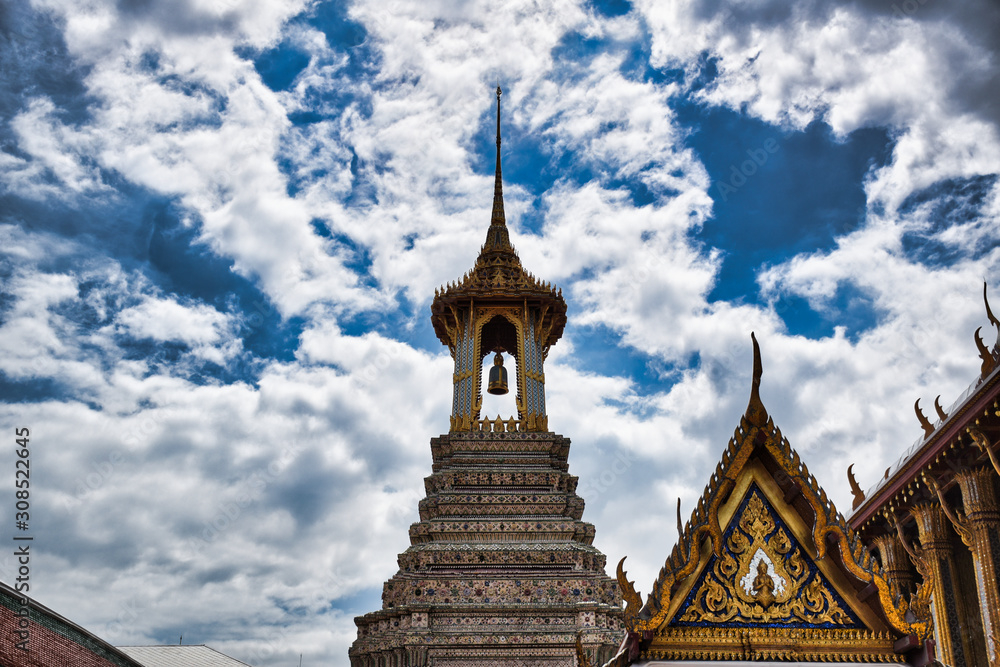 A Thai traditional bell tower (belfry) with detailed, mosaic artwork and gold colored design at Wat Phra Kaew (Temple of the Emerald Buddha) within the precincts of the Grand Palace of Bangkok
