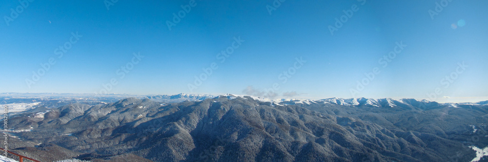Fototapeta premium Sunny Winter Day With The Mountains Full Of Snow, Poiana Brasov, Romania, panorama