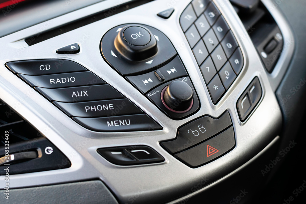 Close up of a vehicle's dashboard infotainment control console.