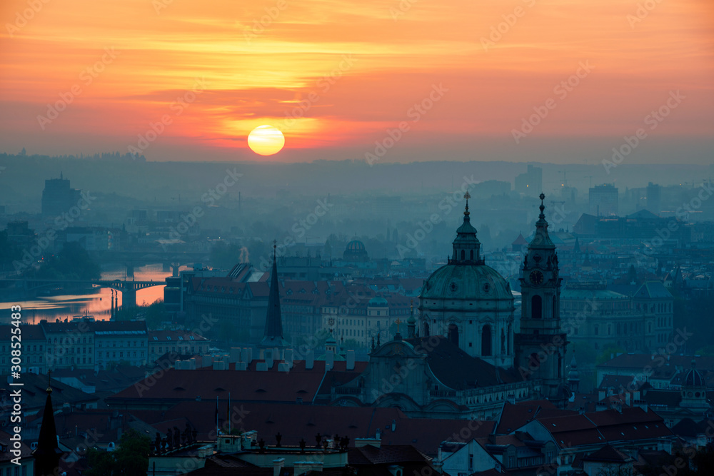 Sunrise behind the tower of St. Nicolas church, Prague, Czech republic