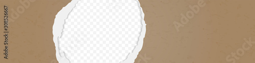 A hole in the ripped recycled paper background. Cardboard or paperboard kraft paper frame