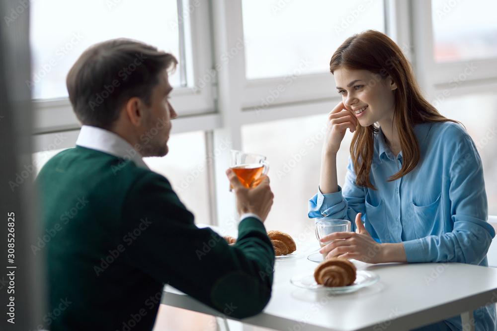 young couple having breakfast in the kitchen