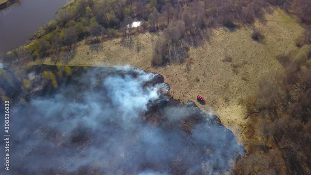 Burning plant field with smoke. Countryside landscape. Aerial view