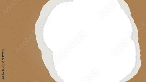 A hole in the ripped recycled paper background. Cardboard or paperboard kraft paper frame