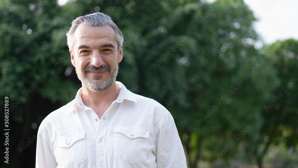 Portrait of middle aged man in the park and smiling. Portrait of middle aged man in the park and smiling.