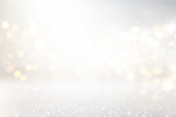 abstract background of glitter vintage lights . silver, gold and white. de-focused