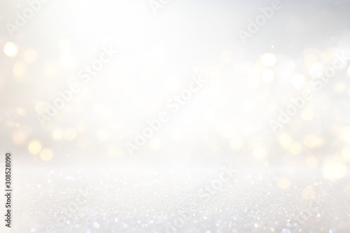abstract background of glitter vintage lights . silver, gold and white. de-focused photo