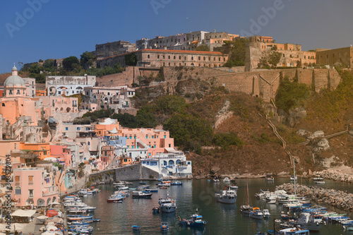 Panoramic view of beautiful Procida on a sunny summer day. Colorful cafes, houses and restaurants, fishing boats and yachts, clear blue sky and the azure sea on the island of Procida, Italy. Napoli © Underwater girls