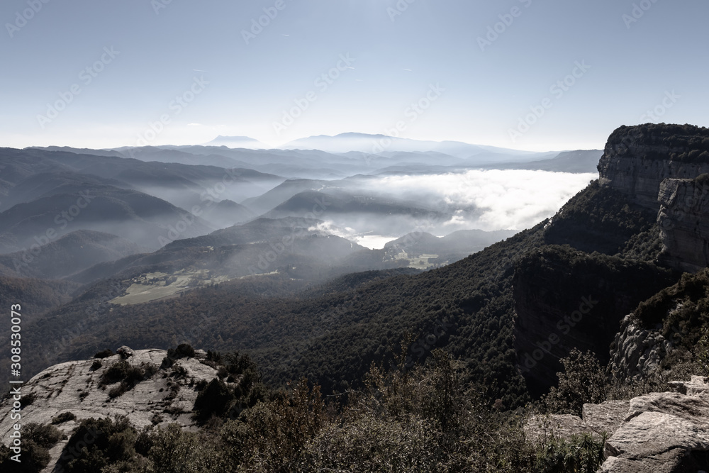 View from the top of the cliffs of Collsacabra as the fog from the mountains and valleys of the Guillerias dissipates, Catalonia, Spain