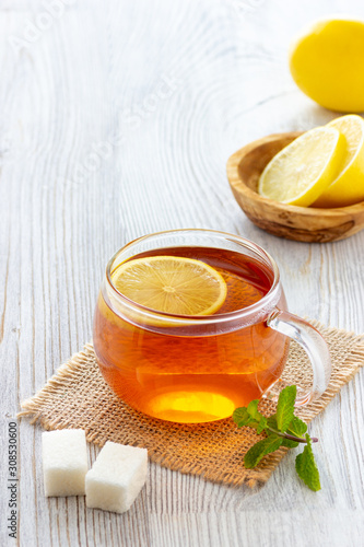 Cup of lemon tea on wooden table.