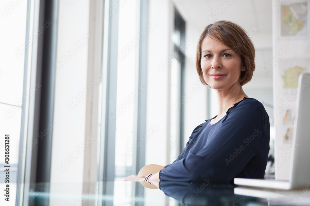 Portrait of confident businesswoman at office desk Portrait of confident businesswoman at office desk