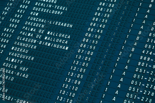 Departures board at the airport. Flight information electronically timetable. Split flap mechanical departures board. Flight schedule. Scoreboard flights